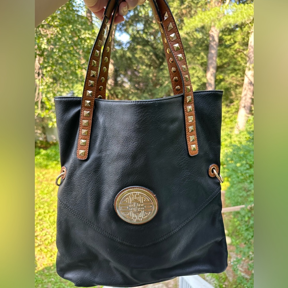 Black leather tote bag with brown leather gold studded straps